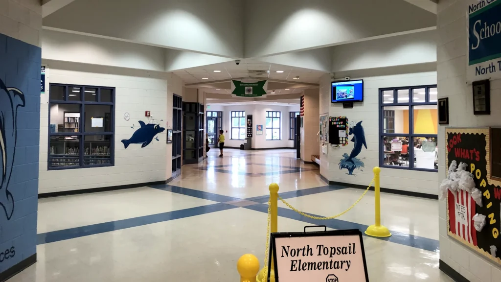 Hallway inside North Topsail Elementary School in Hampstead, NC, with the school's dolphin mascot painted on the wall near the entrance.