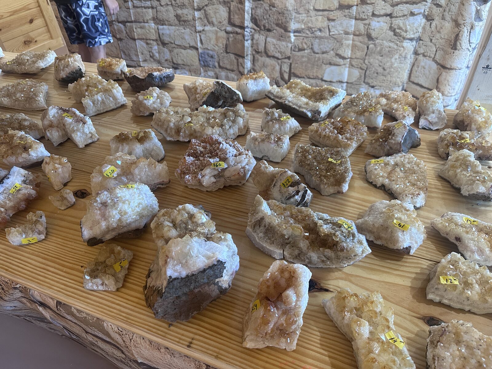 A table covered in citrine clusters of varying sizes